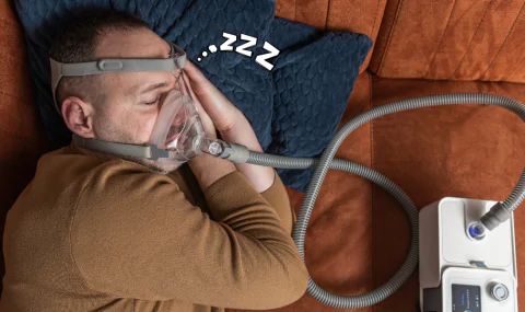 man-sleeping-with-sleep-apnea-machine