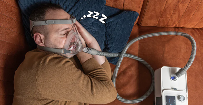 man-sleeping-with-sleep-apnea-machine
